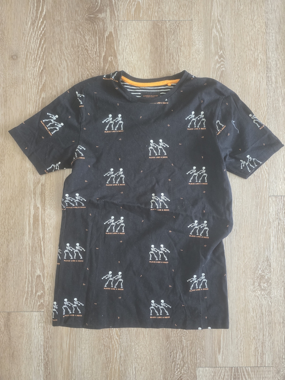 Denim & Flower Black Tee with White Skeleton Print and Orange Accents